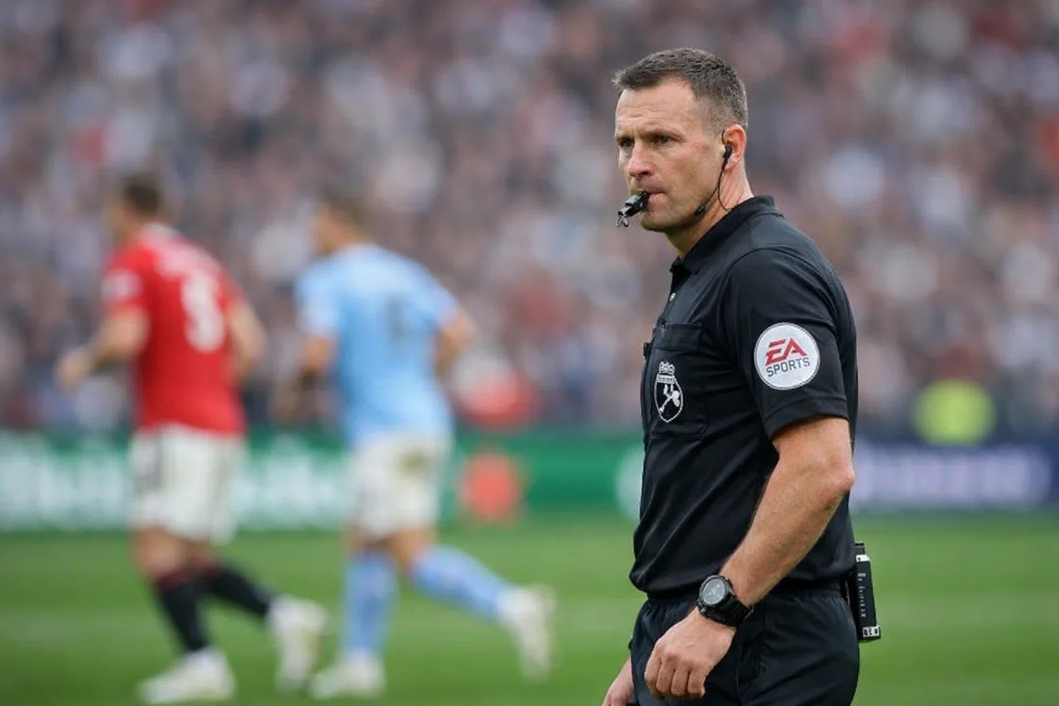 Football referee officiating Premier League match with players nearby