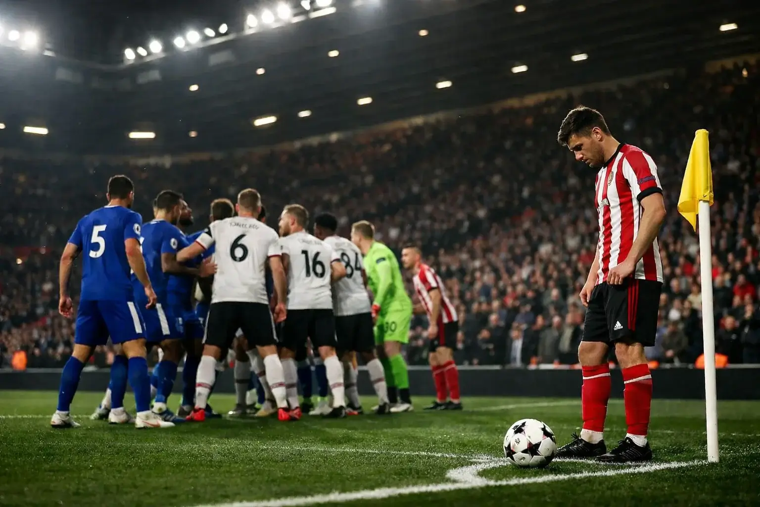 Football players positioning for a corner kick at a Premier League stadium